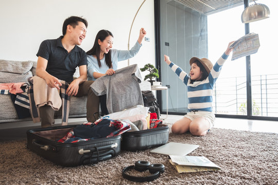 Asian family packing bag/luggage and planning to travel on summer vacation