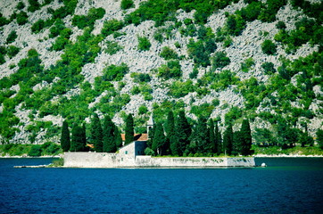 Fototapeta na wymiar Perast Montenegro. island church in perast kotor bay montenegro. Sea view, Monastery on the island in Perast, Montenegro
