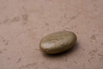 Little gold color  pebble on with background