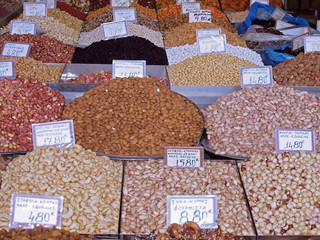 piles of colorful nuts and spices at a food market