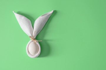 Easter table decoration with napkin in the form of rabbit ears and eggs. Festive  minimalism.