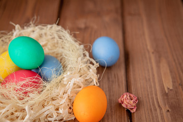 Colorful Easter eggs on wooden background with copy space