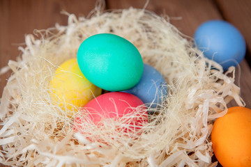 Colorful Easter eggs on wooden background with copy space