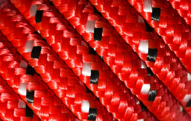 Close up detail of a coiled red nylon rope to make an abstract textured background