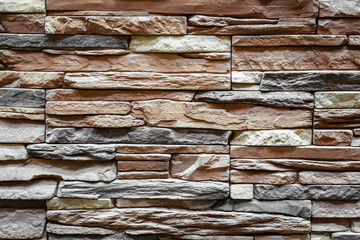 Background of brown stone wall made with blocks . Pattern of slate wall texture and background