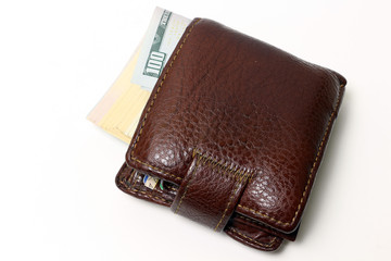 Brown wallet with money isolated on white background.