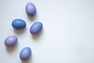 painted eggs on a light purple background Easter