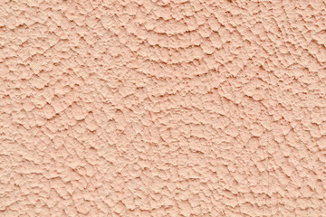 The texture of the wall covered with plaster and painted beige paint