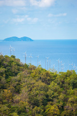 Obraz premium wind turbine generating electricity on mountain near sea.