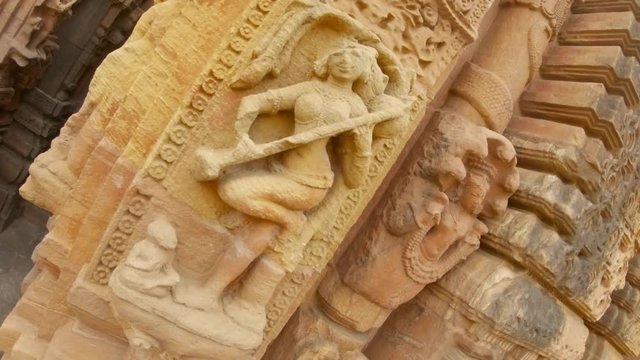 apsara female spirit with veena Indian musician instrument bas-relief on wall of ancient hindu temple Rajarani Bhubaneswar Orissa