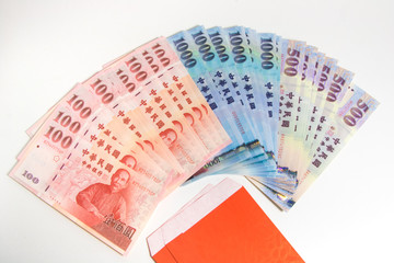 Red envelope packet with Taiwan money on white background for Chinese New Year. Translation: Good luck in the year.