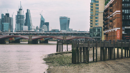 River Thames in low tide with perspective view on The City of London