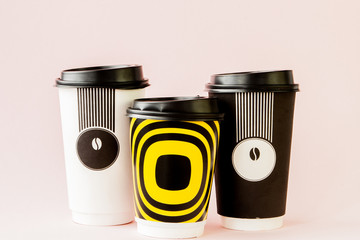 Take-out coffee in thermo cup on a pink background