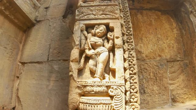 ancient bas-reliefs indian female deity image with big breast and long ears in dance pose old Hindu temple Bhubaneswar Odisha