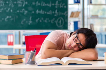 Young male student in the classroom 