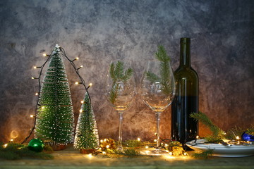 Red wine on table with Christmas tree. Christmas table and tree.