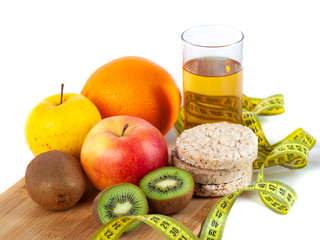 Apple, orange, kiwi with measure tape on white background