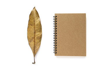 Note book and a dry leaf
