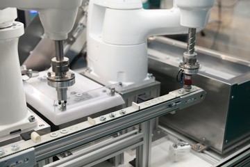Automatic robot arm working in industrial environment sorting out screws