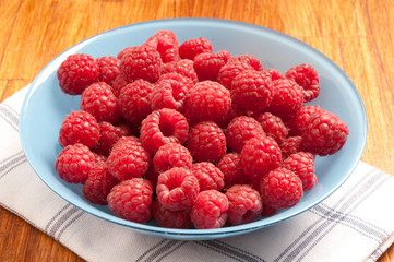 red berries raspberries in a bowl