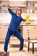 Young man in water leakage from the neighbors concept 