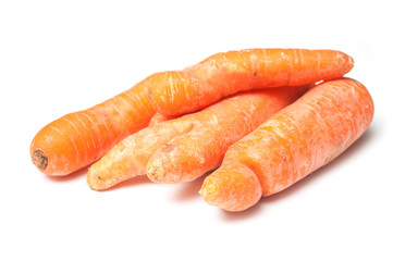 closeup of deformed carrots on white background