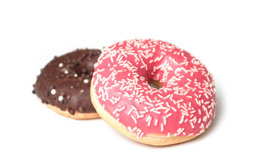 Closeup of pink doughnut and chocolate doughnut on white background