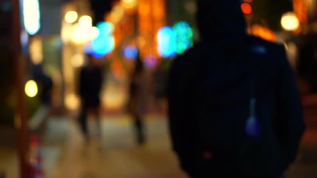 Blur Christmas light and people walking city sidewalk