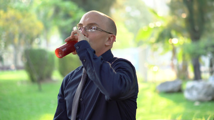 Man Drinking Healthy Fruit Smoothie in Park