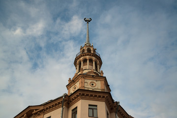 Fototapeta na wymiar Old historical beautiful building with tower on Kamunistycnaja street in Minsk, Belarus