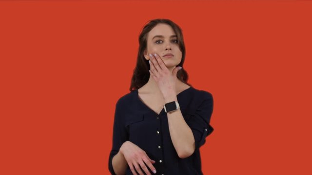 Young woman examining herself and looking for flaws
