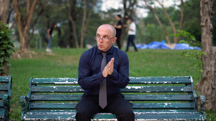 Nervous Late 20s Man Waiting For Date on Park Bench 