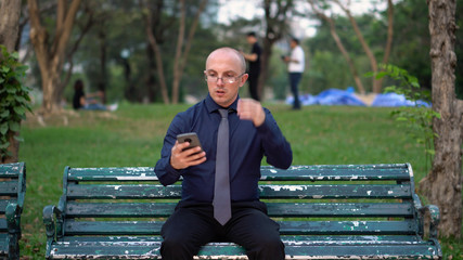 Nervous Late 20s Man Waiting For Date on Park Bench 