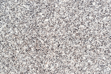 Non polished granite background. Closeup of grey granite texture background