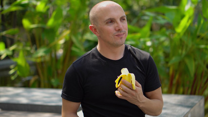 Young Happy Man Eating Banana Park