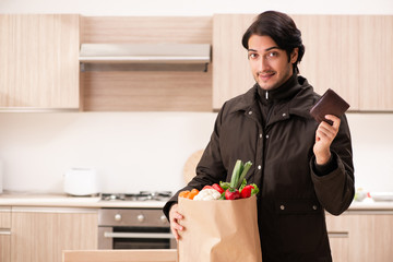 Young handsome man with vegetables in the kitchen 