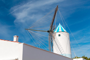 Traditional Old White Windmill against Blue Sky