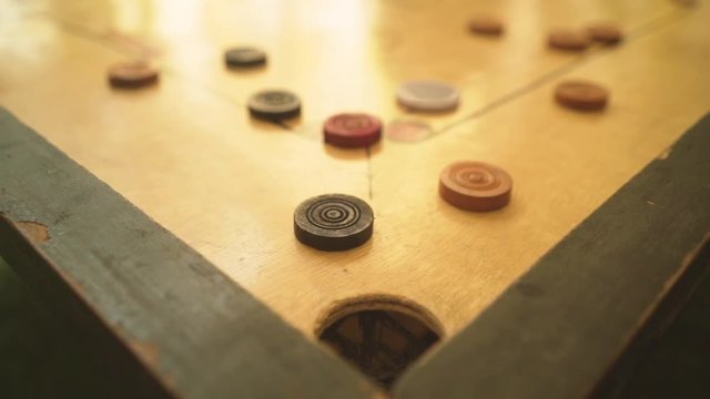 a game of carom with pieces, trying to score ,Carrom board game, slow motion 