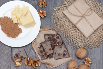 Fototapeta na wymiar Handmade carob chocolate with nuts. Ingredients cocoa butter, carob. Top view.