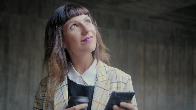 Portrait of nice Caucasian thoughtful business female with mobile phone, using new application in network, social media lifestyle, swiping photos of friends, always up to date connected with internet