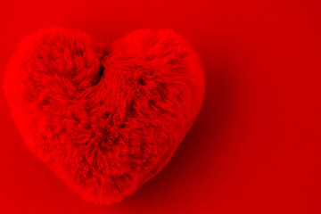 Red puffy heart on a red background