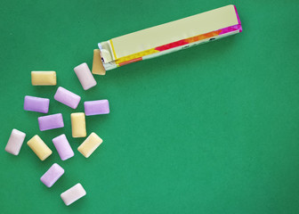 Chewing gum on green background 