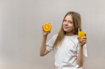 Blonde happy girl holds in her hand a glass of fresh juice. Healthy diet. Veggie and vegan.