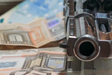 Revolver lying on a pile of money