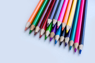 Fototapeta premium Color pencils on a white background, a line of colored pencils. Set of pencils. Children's creativity. Drawing with pencils