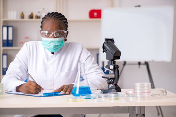 Fototapeta na wymiar Young black chemist working in the lab 