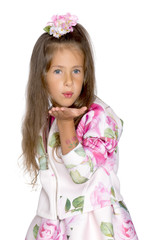 Little girl blowing on the palm