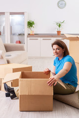 Obraz na płótnie Canvas Middle-aged woman moving to new flat 