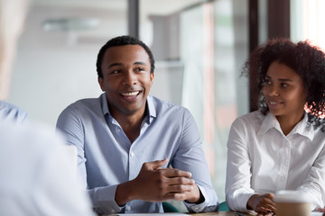 African businessman team leader talking to colleagues at group meeting