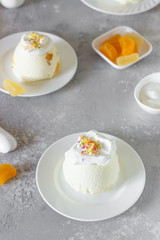 Cottage cheese dessert with apricot filling decorated with whipped cream. 